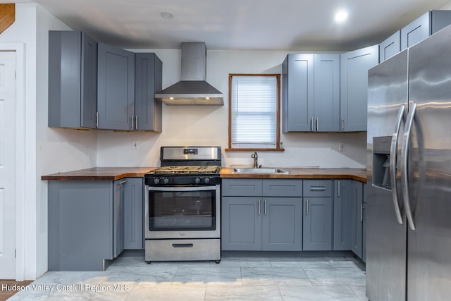 149 2nd St, Connelly, NY 12417 - kitchen featuring stainless steel appliances, wood counters, wall chimney exhaust hood, a sink, and light marble finish flooring