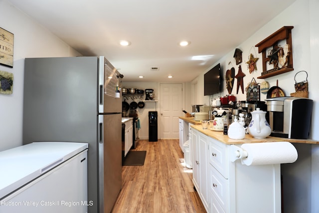 651 Glasco Tpke, Saugerties, NY 12477 - kitchen featuring freestanding refrigerator, light wood-style floors, light countertops, and white cabinetry