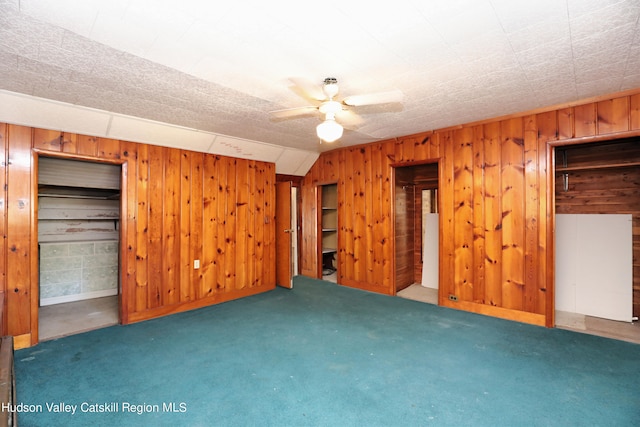 651 Glasco Tpke, Saugerties, NY 12477 - unfurnished bedroom with carpet flooring, wood walls, and multiple closets