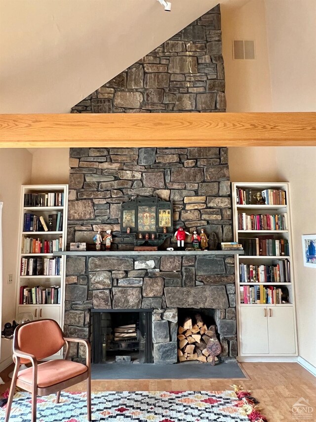 126 Shaker Ridge Dr, Canaan, NY 12029 - sitting room featuring a stone fireplace, built in features, wood finished floors, and lofted ceiling