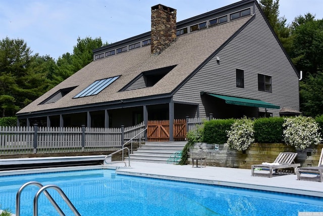 126 Shaker Ridge Dr, Canaan, NY 12029 - back of property with roof with shingles, a chimney, a patio, and fence