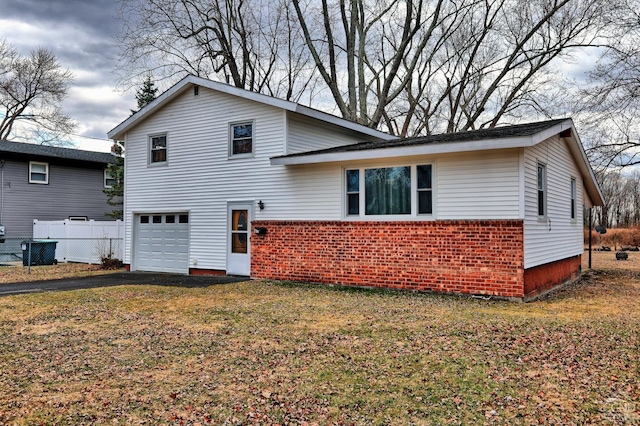 17 Bogardus Ave, Catskill, NY 12414 - view of front of house with a garage, brick siding, driveway, and central air condition unit