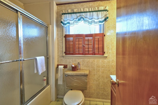 17 Bogardus Ave, Catskill, NY 12414 - full bathroom featuring tile walls, combined bath / shower with glass door, toilet, and tile patterned flooring