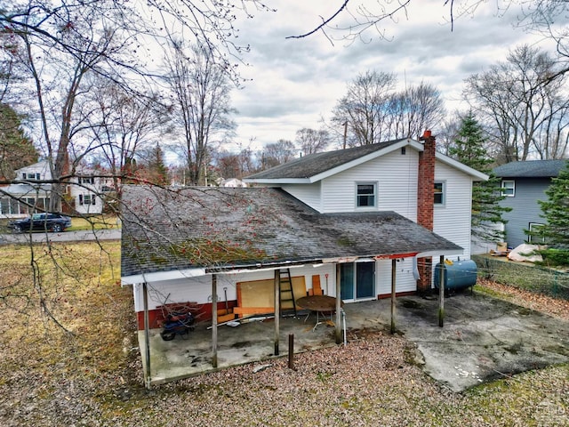 17 Bogardus Ave, Catskill, NY 12414 - rear view of property featuring a patio area, roof with shingles, and a chimney