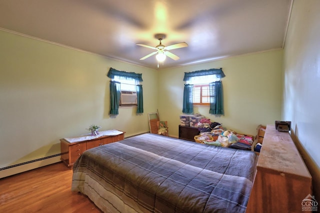 17 Bogardus Ave, Catskill, NY 12414 - bedroom with crown molding, multiple windows, wood finished floors, cooling unit, and a baseboard heating unit