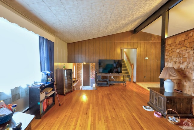 17 Bogardus Ave, Catskill, NY 12414 - living room with lofted ceiling, hardwood / wood-style floors, wooden walls, and stairs