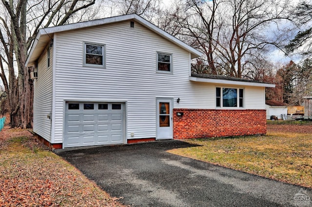 17 Bogardus Ave, Catskill, NY 12414 - split level home featuring a garage, driveway, and brick siding