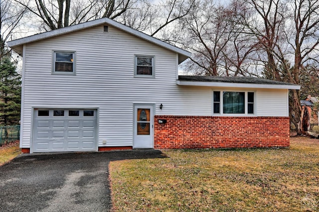 17 Bogardus Ave, Catskill, NY 12414 - view of front of house featuring brick siding, a garage, a front yard, and driveway
