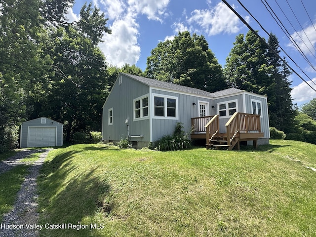 2206 County Route 7, Copake, NY 12516 - back of property featuring an outdoor structure, a wooden deck, a garage, driveway, and a yard