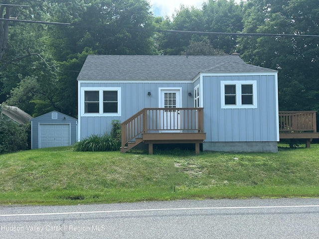 2206 County Route 7, Copake, NY 12516 - bungalow-style home with roof with shingles, a garage, an outbuilding, and a front lawn