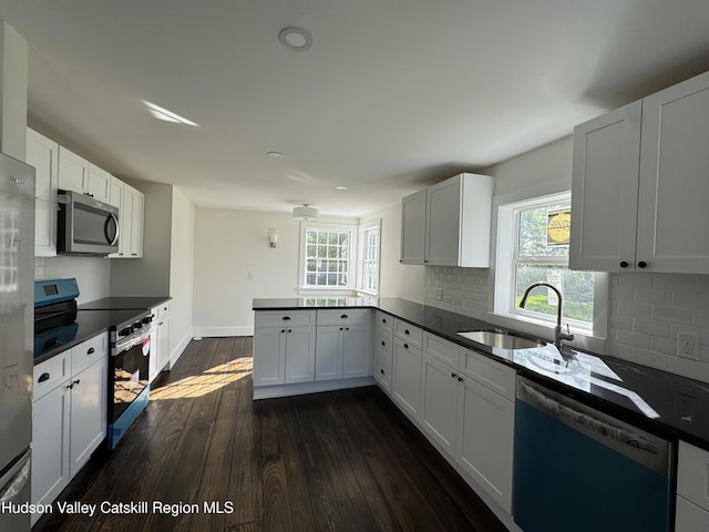 237 Main St, Copake, NY 12521 - kitchen featuring stainless steel appliances, a sink, dark countertops, a peninsula, and recessed lighting