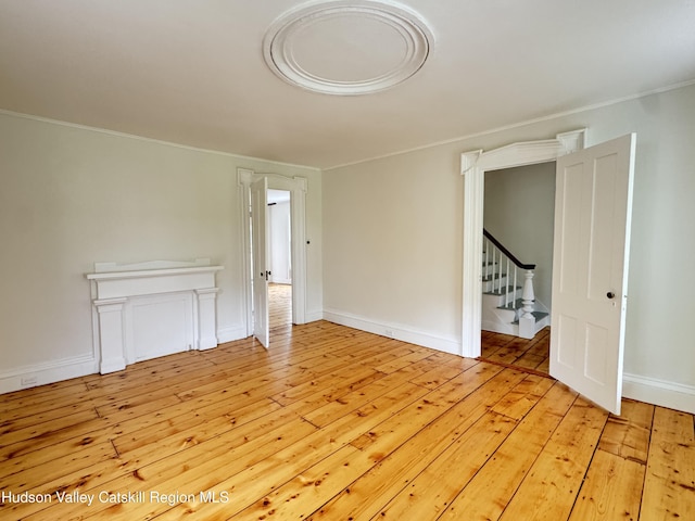 237 Main St, Copake, NY 12521 - spare room with light wood finished floors, crown molding, baseboards, and stairway