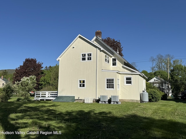 237 Main St, Copake, NY 12521 - rear view of house with a yard, a chimney, and central AC