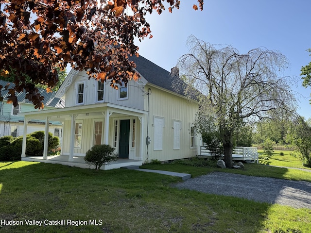 237 Main St, Copake, NY 12521 - view of front of property featuring a porch, a front lawn, board and batten siding, and a chimney