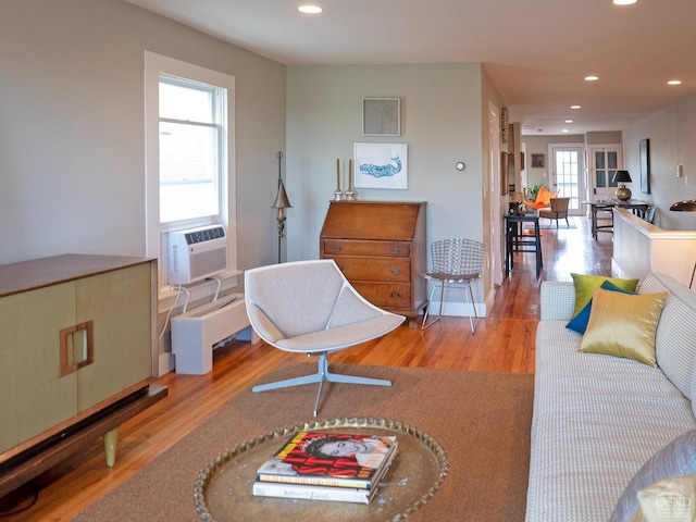 living room with wood finished floors, recessed lighting, and cooling unit