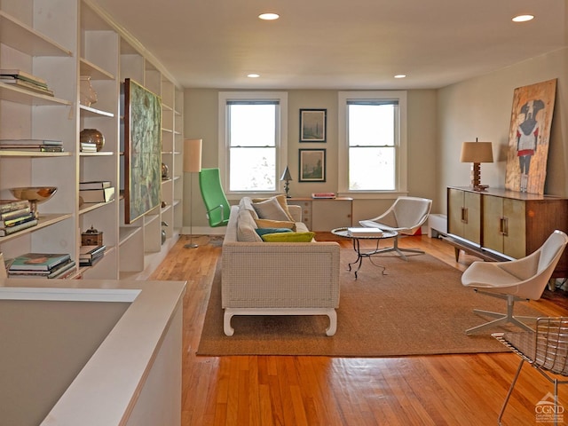 sitting room featuring hardwood / wood-style floors and recessed lighting