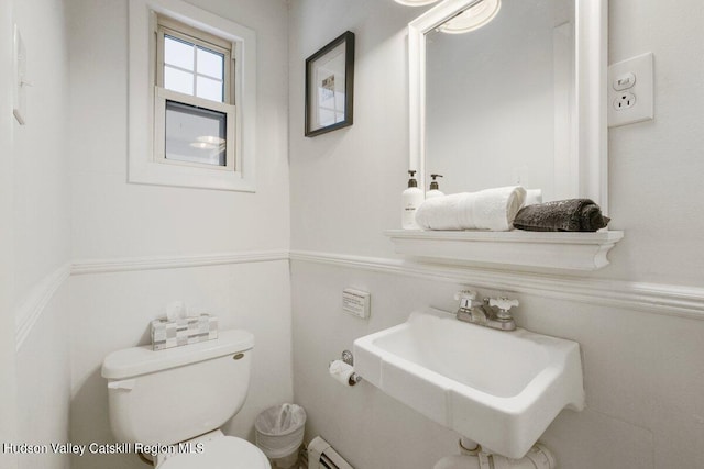 bathroom with a baseboard radiator, toilet, and sink