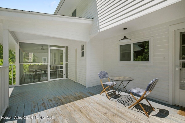 wooden deck featuring ceiling fan