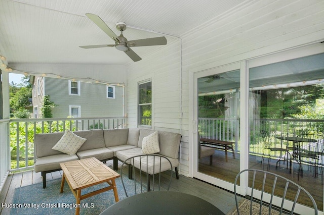 sunroom featuring ceiling fan and lofted ceiling