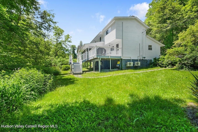 view of home's exterior with central air condition unit, a lawn, and a wooden deck