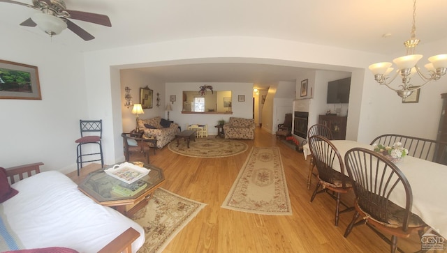 69 Windham Ridge Rd Unit 16F, Windham, NY 12496 - living area featuring wood finished floors, a ceiling fan, a chandelier, and a fireplace