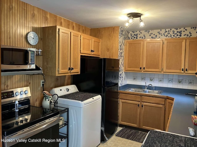 44 Overlook Dr, Woodstock, NY 12498 - kitchen with stainless steel appliances, washer / clothes dryer, wood walls, and tasteful backsplash