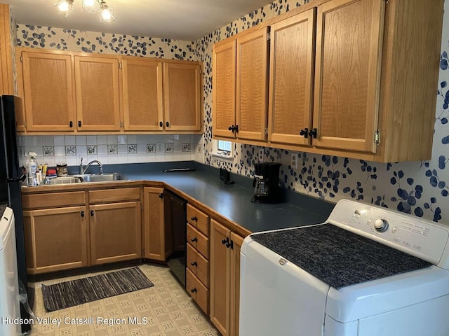 44 Overlook Dr, Woodstock, NY 12498 - kitchen featuring washer / clothes dryer, black dishwasher, dark countertops, light flooring, and wallpapered walls