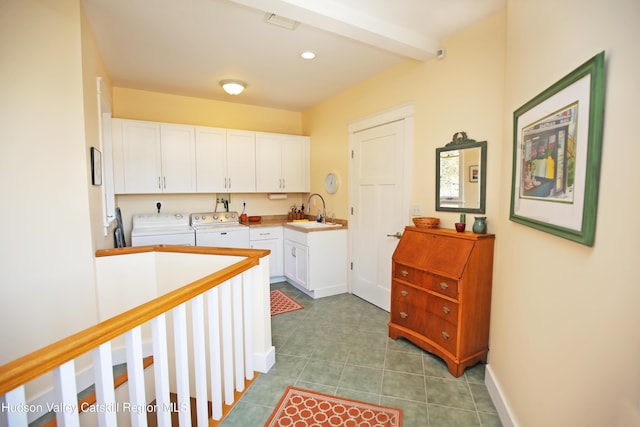 kitchen with separate washer and dryer, tile patterned flooring, a sink, and white cabinetry