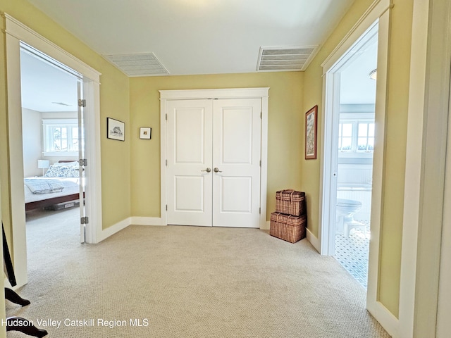 interior space with carpet floors, visible vents, and baseboards