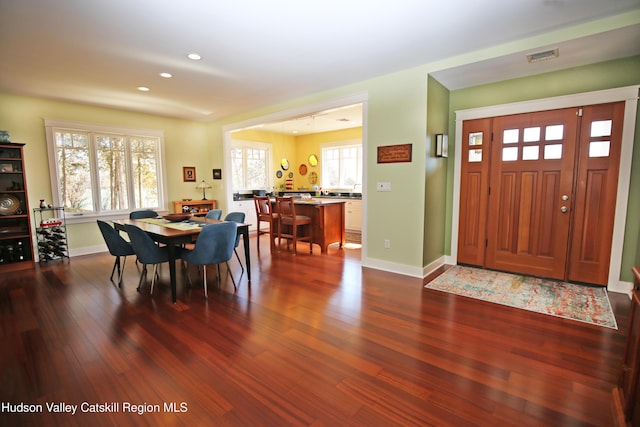 entrance foyer featuring dark wood-type flooring, recessed lighting, visible vents, and baseboards