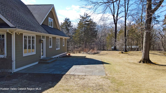 view of yard with entry steps and a patio