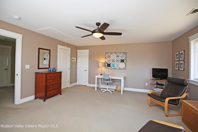 carpeted office featuring visible vents, ceiling fan, attic access, and baseboards