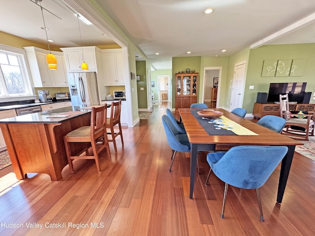 dining room with light wood-type flooring, baseboards, and recessed lighting