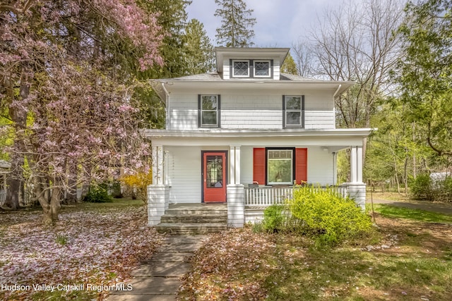 american foursquare style home with a porch