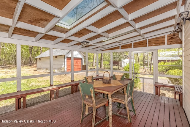 sunroom / solarium featuring outdoor dining area and a healthy amount of sunlight