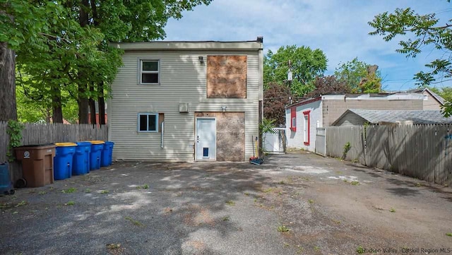 back of property featuring fence