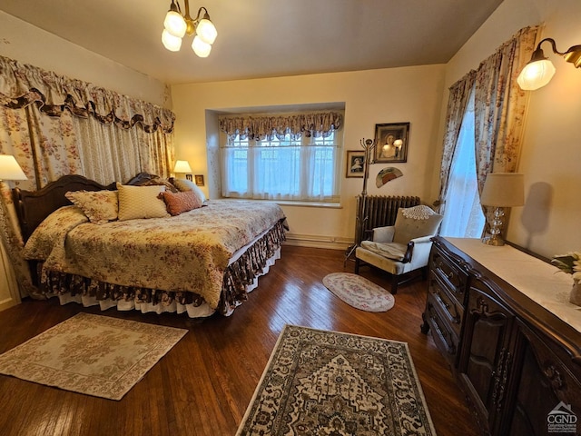 bedroom featuring radiator, a chandelier, dark wood-style flooring, and baseboards