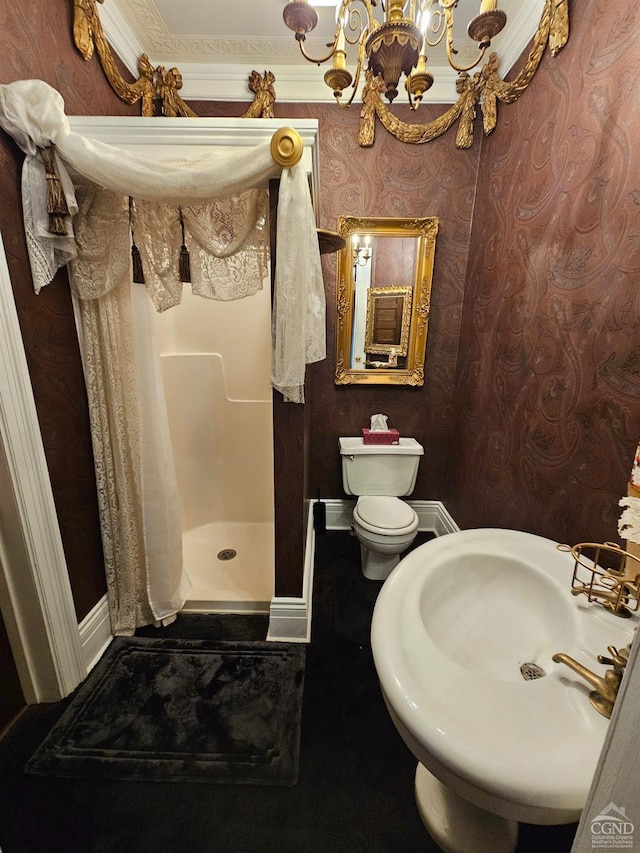 bathroom featuring a shower stall, a sink, baseboards, a chandelier, and toilet