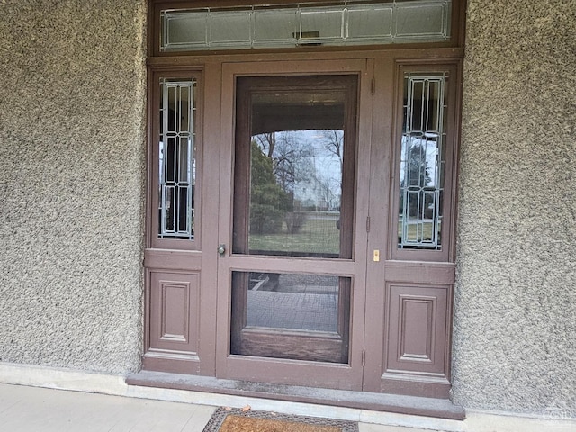 doorway to property with stucco siding