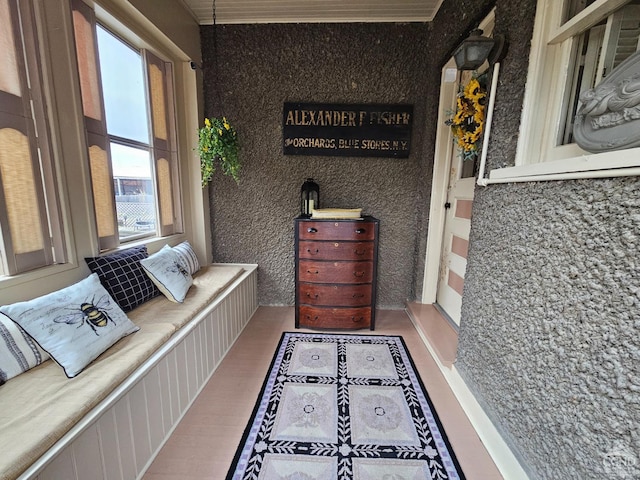 sitting room with wood finished floors and ornamental molding
