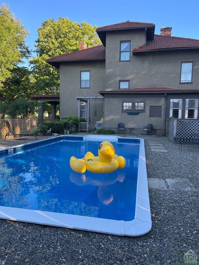 view of swimming pool with fence