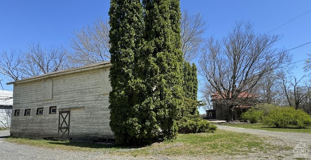 view of property exterior with a barn and an outdoor structure