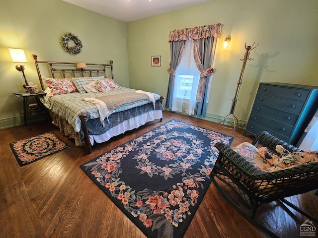 bedroom featuring wood finished floors and baseboards
