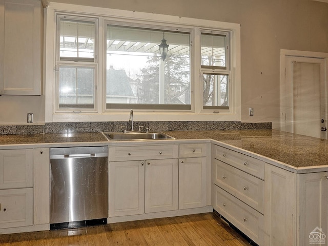 517-519 Washington St, Hudson, NY 12534 - kitchen featuring stainless steel dishwasher, tile countertops, a sink, and white cabinetry