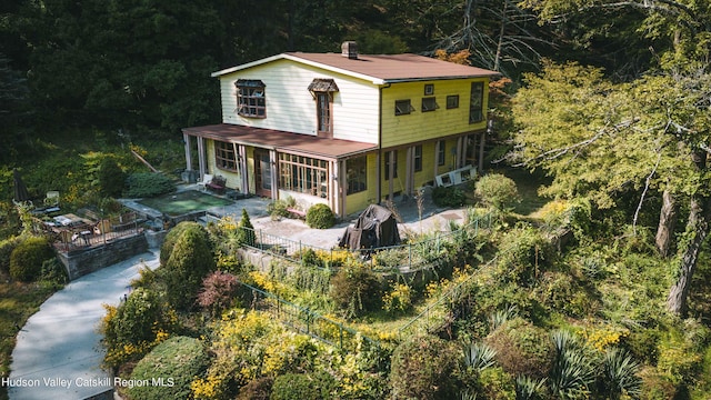 back of property featuring a porch