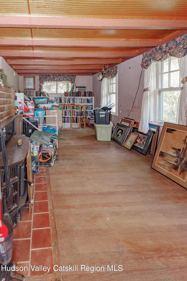 interior space with hardwood / wood-style floors, plenty of natural light, and beam ceiling