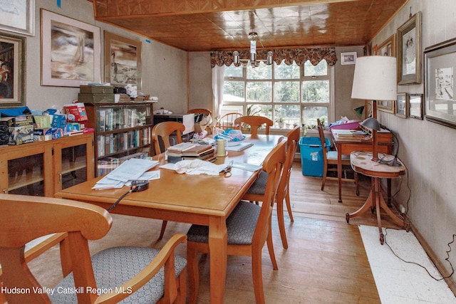 dining area featuring light hardwood / wood-style flooring and a notable chandelier