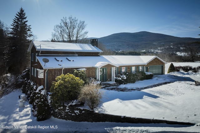 view of front of home featuring a mountain view and a garage