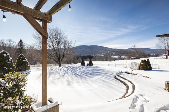 snowy yard with a mountain view