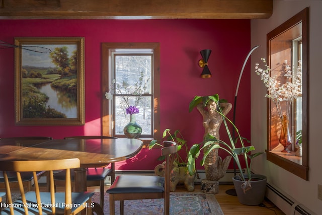 dining area with hardwood / wood-style flooring and baseboard heating